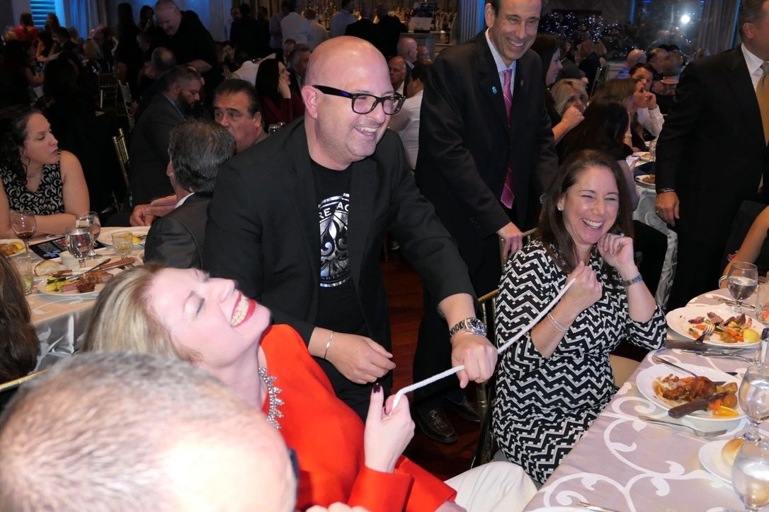 Anthony Sausa sharing close-up magic with guests at an event